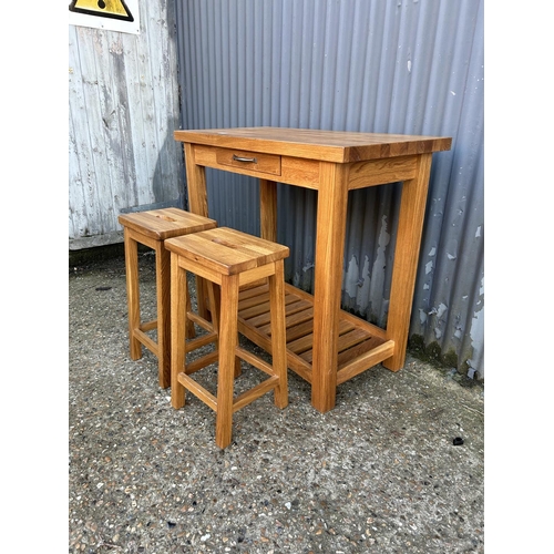 17 - A good quality modern light oak breakfast bar / table with two stowaway stools