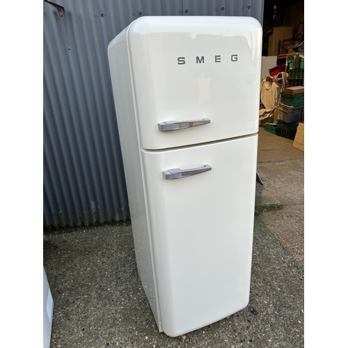 19b - A modern white SMEG fridge freezer with handbook