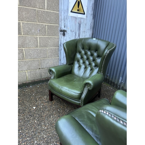 350a - A pair of green leather chesterfield wing back armchairs