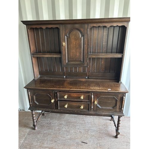 354 - An oak dresser, having plate rack top over two drawer and two door base