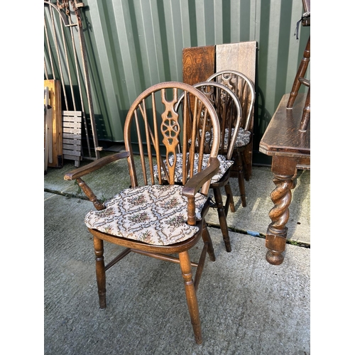 355 - Oak wind out dining table with two extension leaves together with a set of 8 wheel back dining chair... 