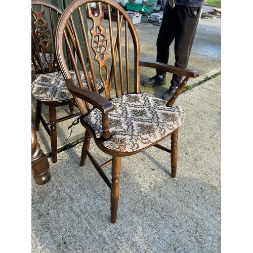 355 - Oak wind out dining table with two extension leaves together with a set of 8 wheel back dining chair... 