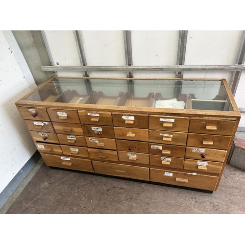 40 - A vintage haberdashery shop serving counter glazed to the top and front with 24 drawers 183x61x92