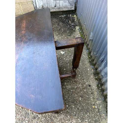 5 - A carved oak hall table with telescopic leg extending to support a fold over top