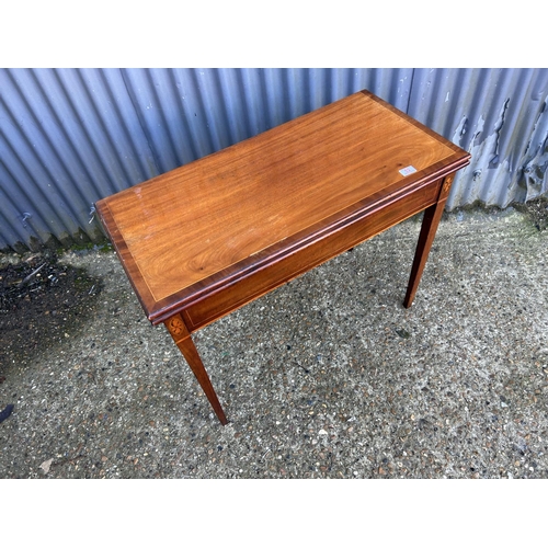 52 - A victorian mahogany fold over tea table with inlay