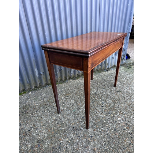 52 - A victorian mahogany fold over tea table with inlay