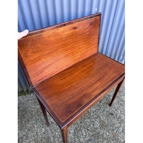 52 - A victorian mahogany fold over tea table with inlay