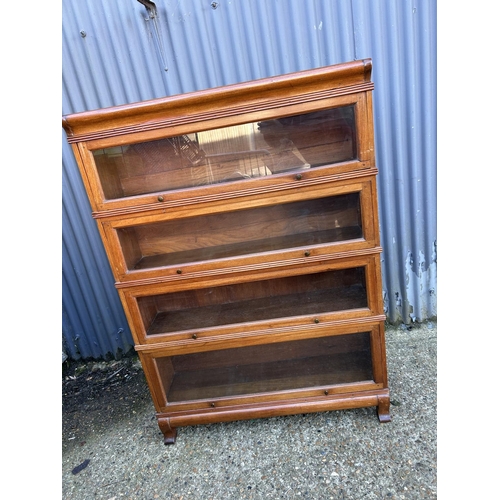 54 - An early 20th century oak four section stacking bookcase with up and over glazed doors 107x30x152