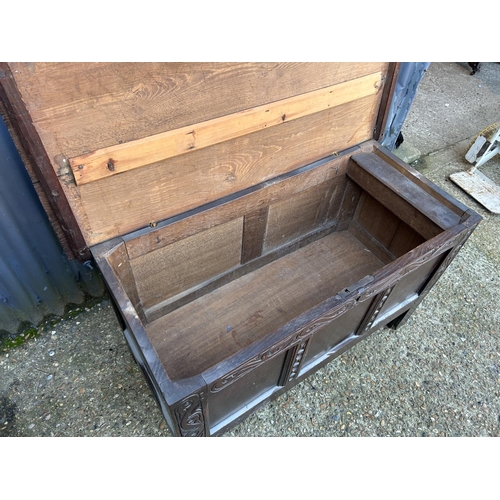 57 - An antique carved  oak three panel blanket box chest  110x50x64