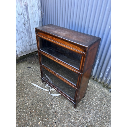 63 - A 20th century globe wernicke style oak three section stacking bookcase with up and over doors 87x31... 