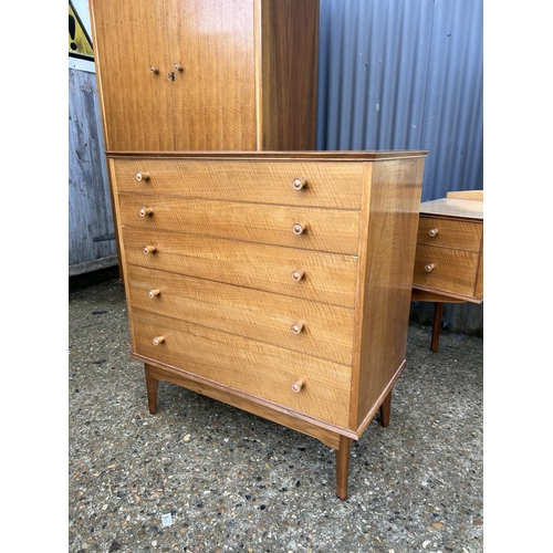 65 - A mid century three piece bedroom suite by ALFRED COX consisting of a five drawer chest of drawers, ... 