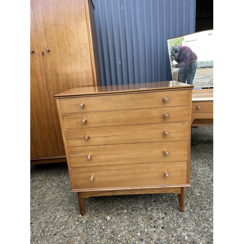 65 - A mid century three piece bedroom suite by ALFRED COX consisting of a five drawer chest of drawers, ... 