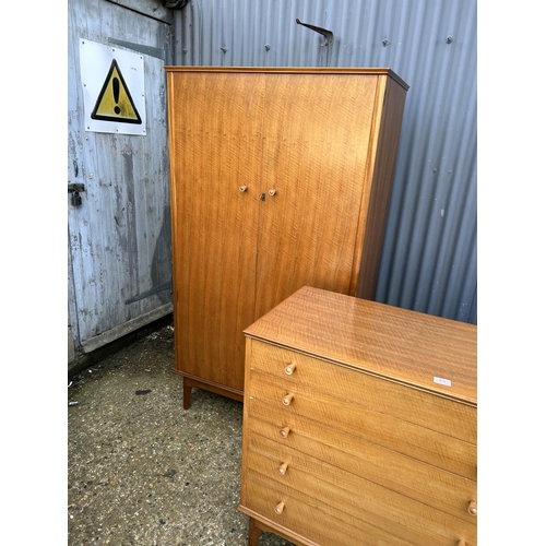 65 - A mid century three piece bedroom suite by ALFRED COX consisting of a five drawer chest of drawers, ... 