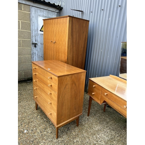 65 - A mid century three piece bedroom suite by ALFRED COX consisting of a five drawer chest of drawers, ... 