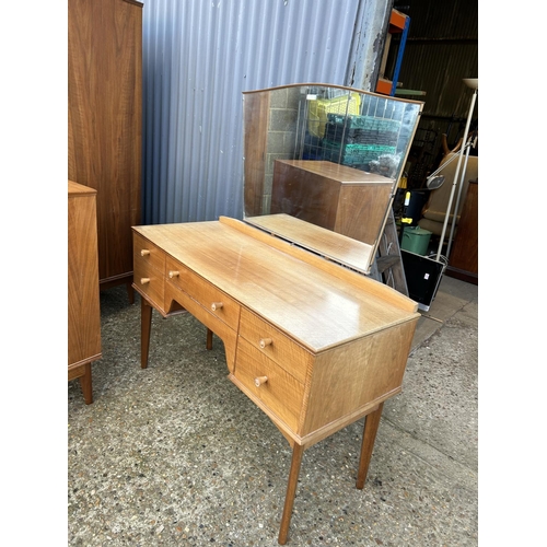 65 - A mid century three piece bedroom suite by ALFRED COX consisting of a five drawer chest of drawers, ... 