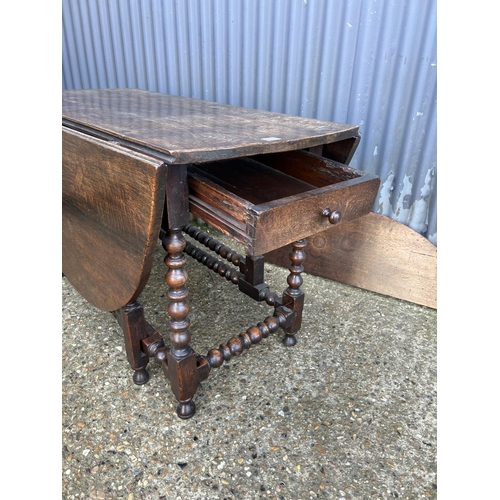 67 - A large antique oak gateleg table with drawer