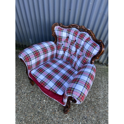 72 - A newly upholstered Rococo style armchair with tartan pattern upholstery