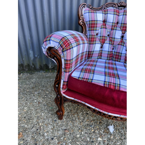 72 - A newly upholstered Rococo style armchair with tartan pattern upholstery