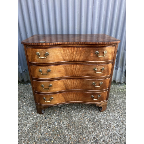 8 - A reproduction mahogany serpentine chest of four drawers