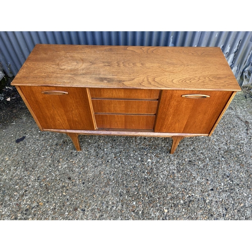 94 - Mid century teak three drawer sideboard, 128 x 44 x 73cms