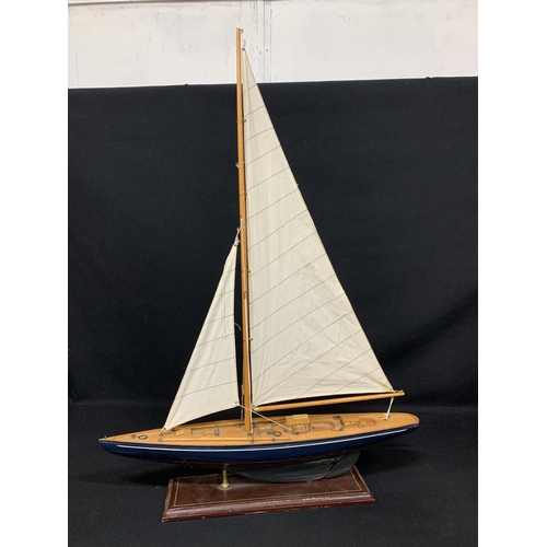 526 - Model wooden yacht on stand, height 86cms, length of yacht 71cms