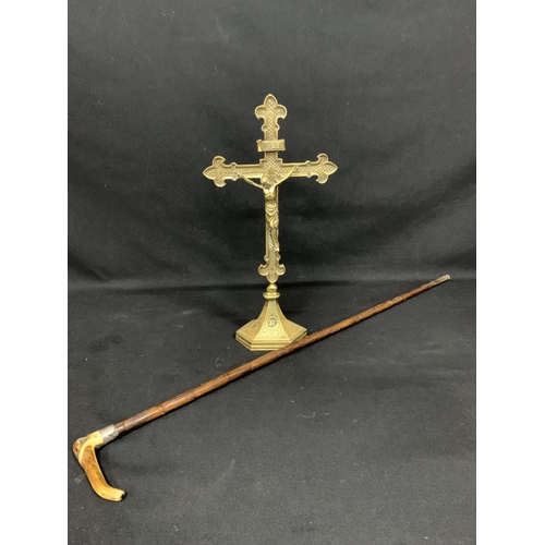 555 - Brass crucifix, height 45cms and Silver banded walking stick