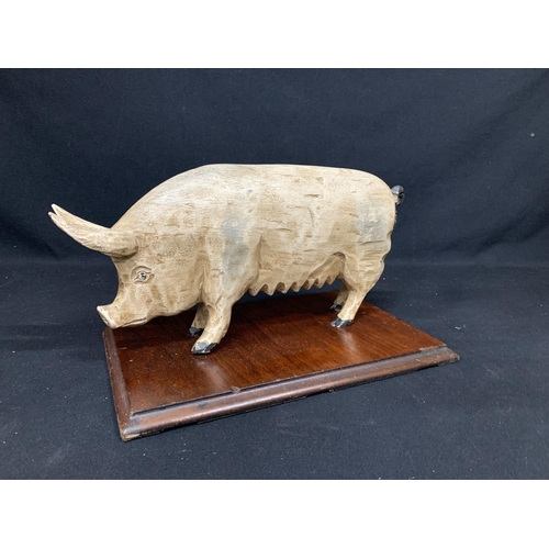 568 - Carved Wooden Pig on stand (Butchers shop display?) Length of plinth 42cms, height 26cms