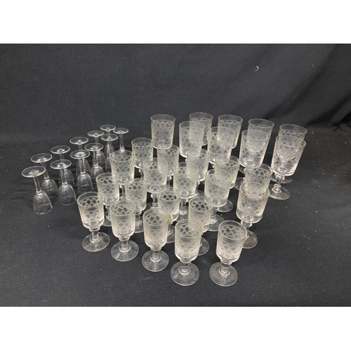 610 - 28 matching etched glasses and 11 liquor glasses