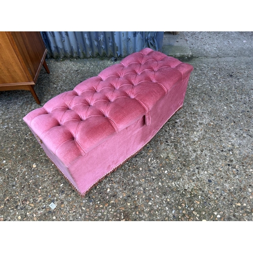 96 - A pink upholstered ottoman