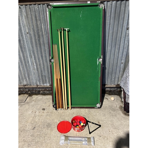 100 - A folding snooker table with cues, balls and score board