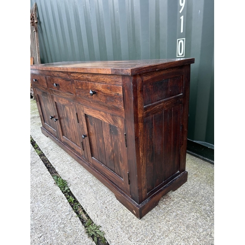 118 - An Indonesian hardwood sideboard with three drawers over three cupboards 170x44x80