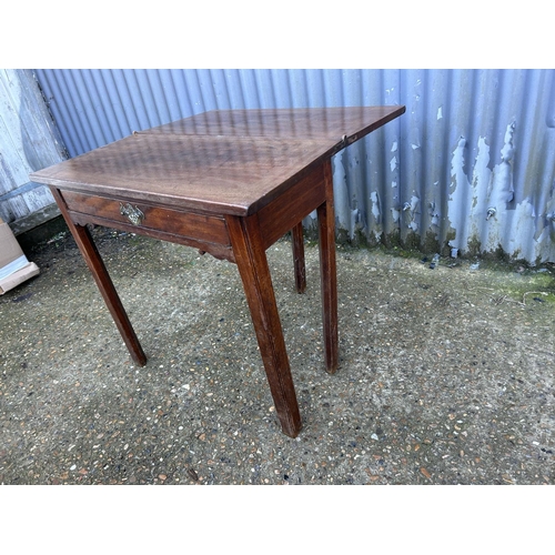 11 - A Georgian mahogany fold over tea table 76x36x75