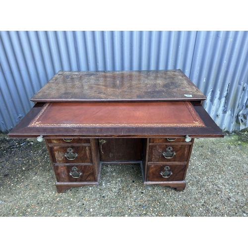14 - An Antique kneehole writing desk with sliding leather top writing surface, walnut veneered on oak 93... 