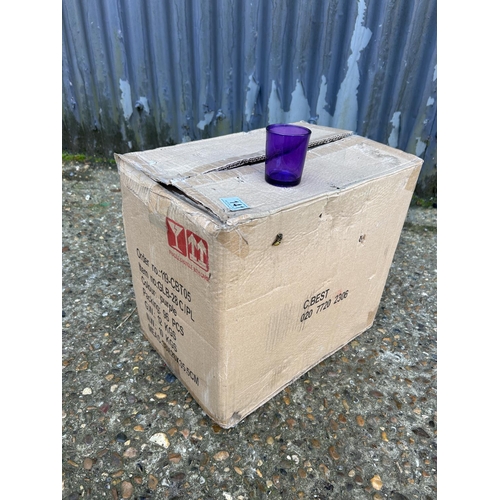 141 - A box of 96 purple glass tea lights