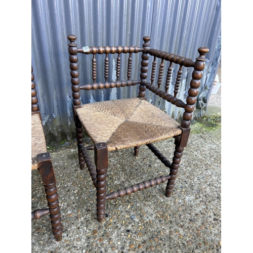 166 - A pair of bobbin oak corner chairs with rush seats