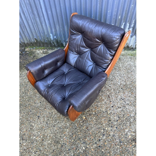 169 - A retro g plan teak framed armchair with brown leather seat