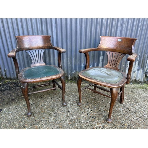 172 - A pair of 20th century oak desk chairs with green leather seats