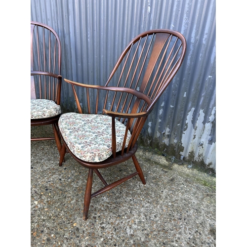 177 - A pair of dark ercol stick back armchairs