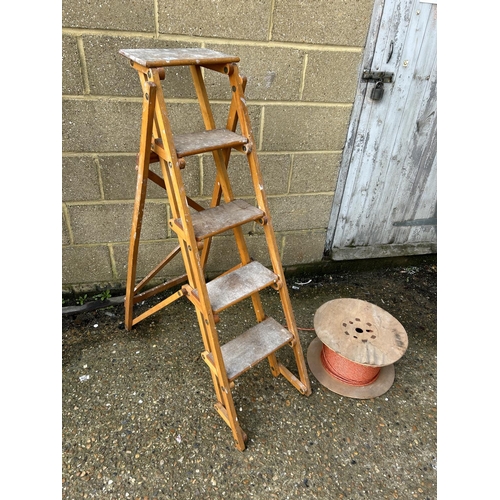 214 - A vintage wooden step ladder together with a roll of rope