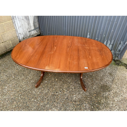 219 - An oval g plan teak extending dining table