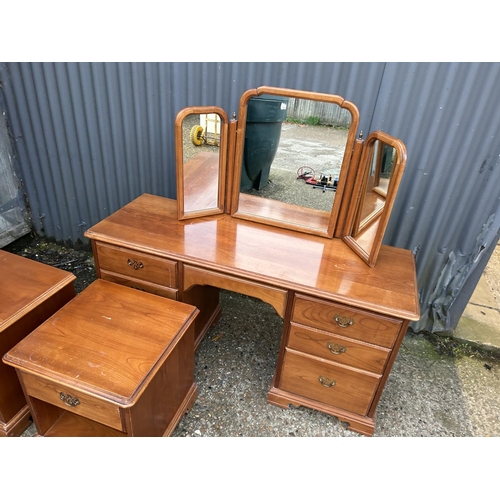 225 - A modern cherrywood effect dressing table together with matching pair of bedside chests