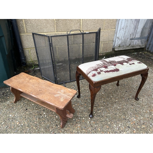 226 - AN iron three section folding fire guard together with a tapestry top stool and an elm bench