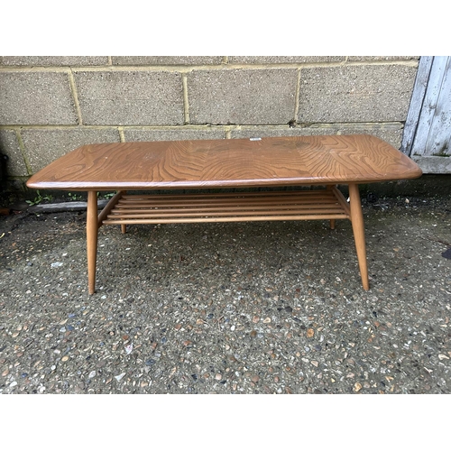 230 - A mid century Ercol light elm coffee table. Size 105 x 41 x 36 cms