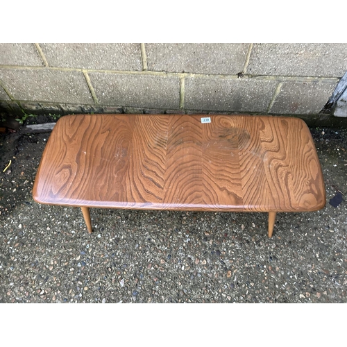 230 - A mid century Ercol light elm coffee table. Size 105 x 41 x 36 cms