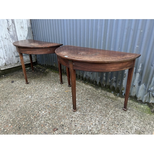 233 - A pair of victorian mahogany demi lune tables joining to create a circular dining table