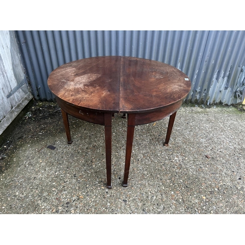 233 - A pair of victorian mahogany demi lune tables joining to create a circular dining table