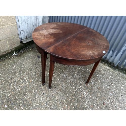 233 - A pair of victorian mahogany demi lune tables joining to create a circular dining table