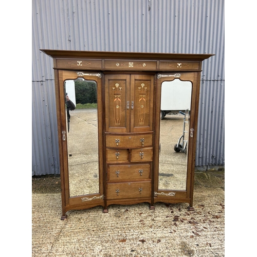 244 - Shapland & Petter, Barnstaple, a triple section walnut wardrobe circa 1900, Art Nouveau inlaid throu... 