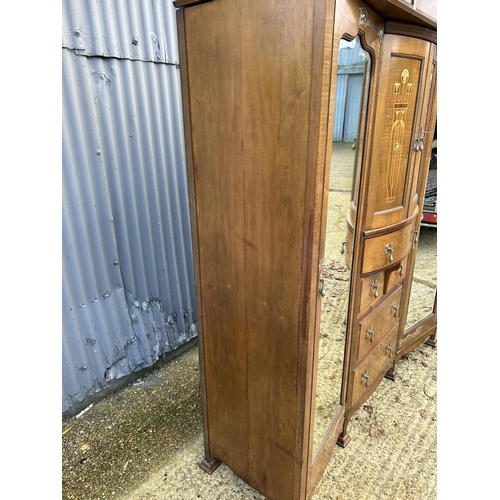 244 - Shapland & Petter, Barnstaple, a triple section walnut wardrobe circa 1900, Art Nouveau inlaid throu... 