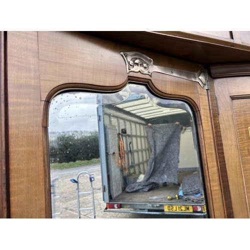 244 - Shapland & Petter, Barnstaple, a triple section walnut wardrobe circa 1900, Art Nouveau inlaid throu... 